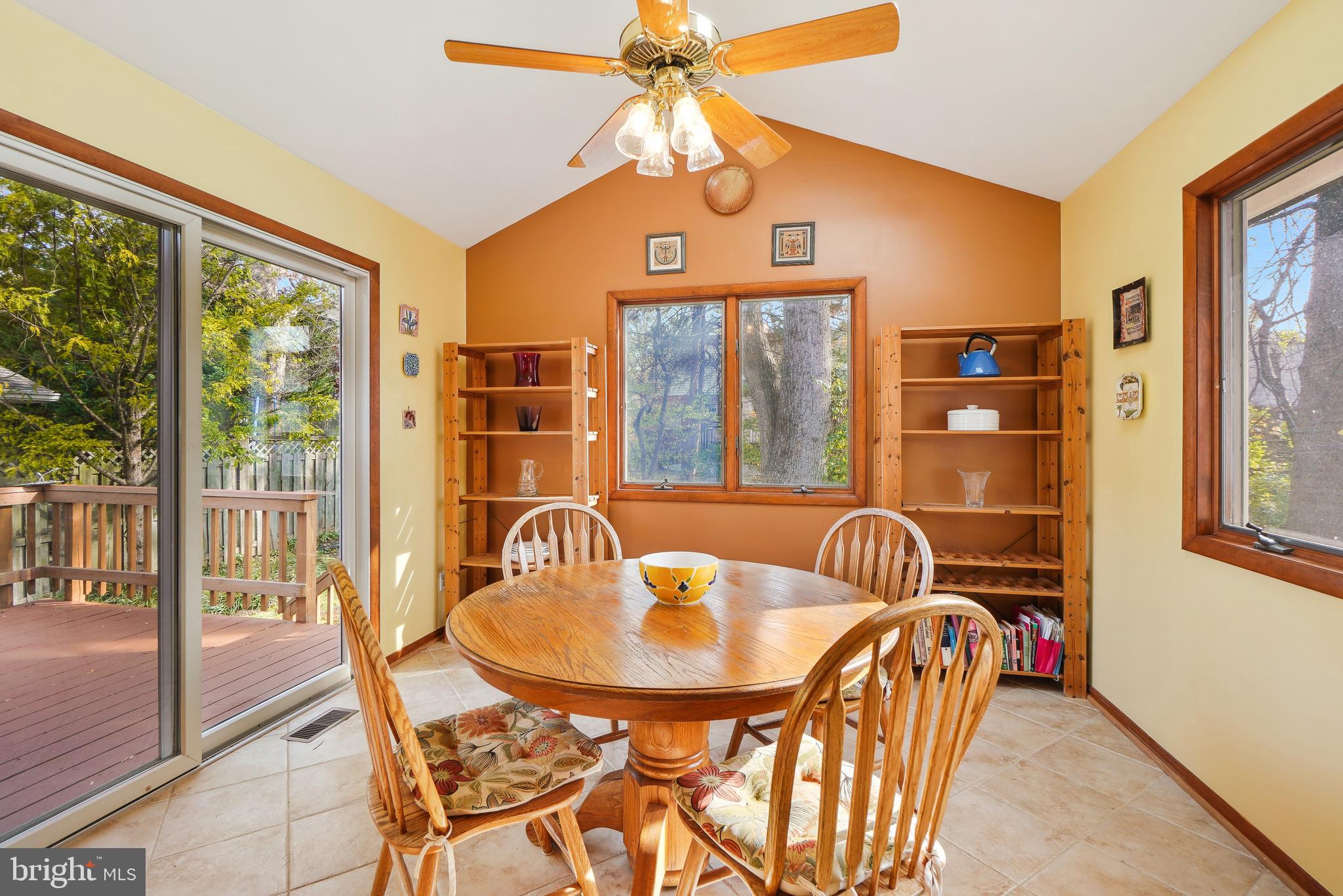 9127 Kirkdale Road Bethesda, MD 20817 - Photo 11 of 34 a dining room with furniture a chandelier and a rug