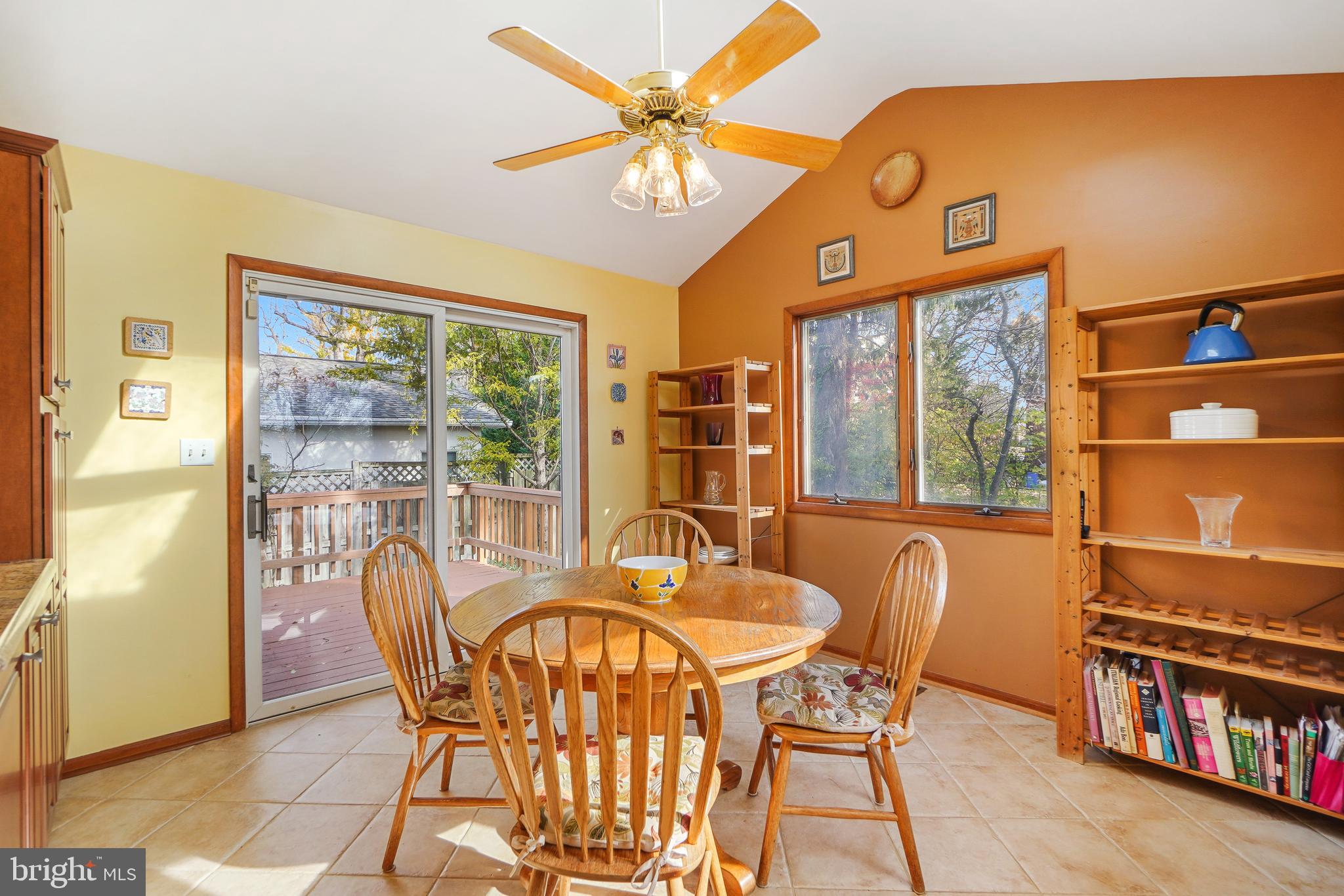9127 Kirkdale Road Bethesda, MD 20817 - Photo 12 of 34 a dining room with furniture a floor to ceiling window and a chandelier