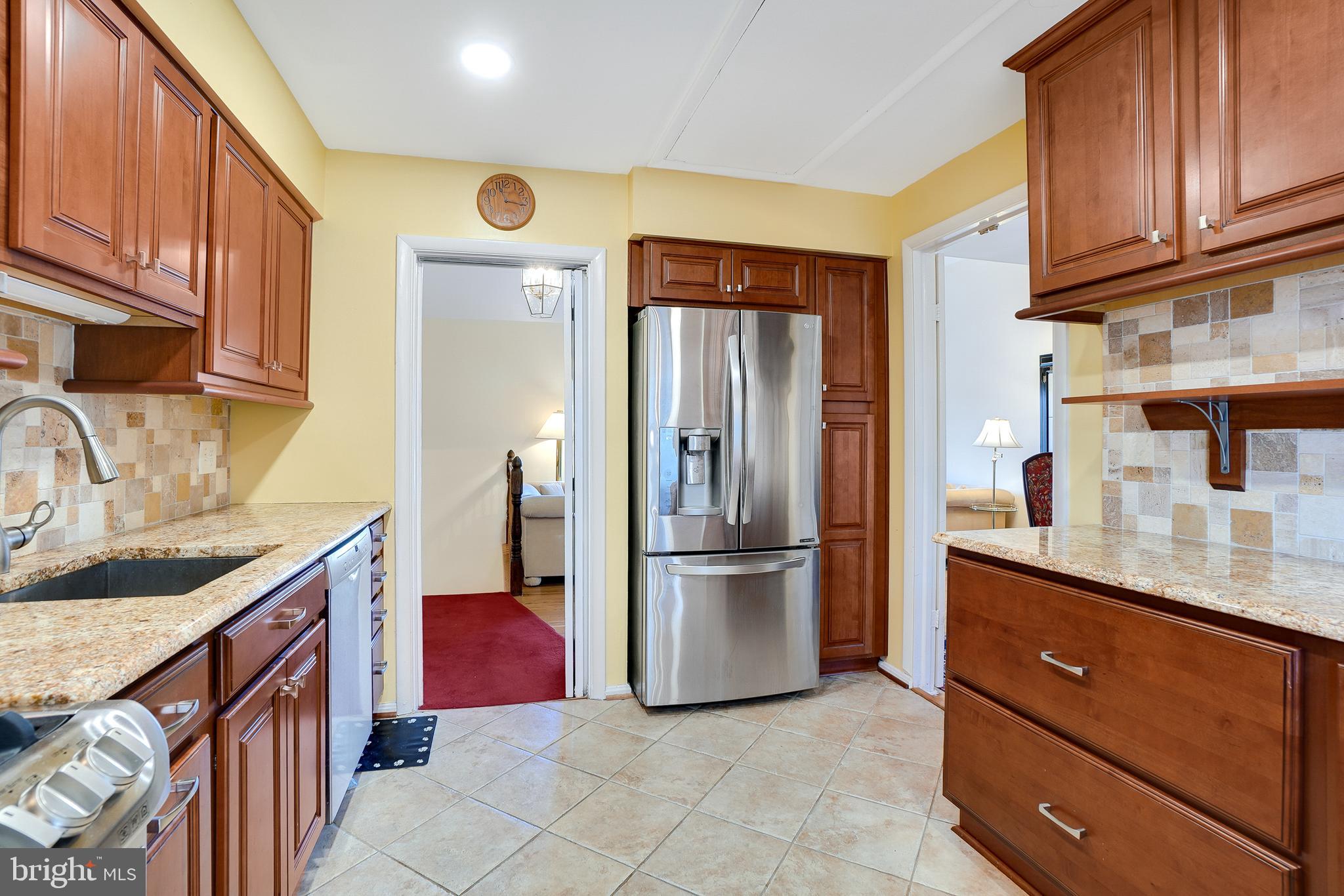 9127 Kirkdale Road Bethesda, MD 20817 - Photo 14 of 34 a kitchen with stainless steel appliances granite countertop a refrigerator and a sink