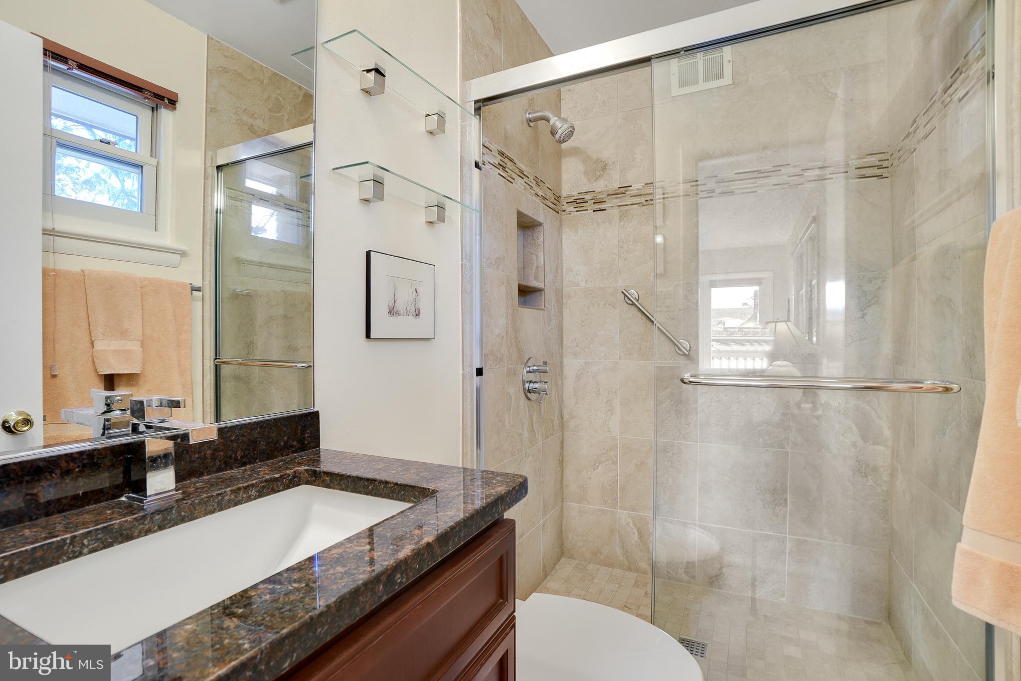 9127 Kirkdale Road Bethesda, MD 20817 - Photo 16 of 34 a bathroom with a granite countertop sink toilet and shower