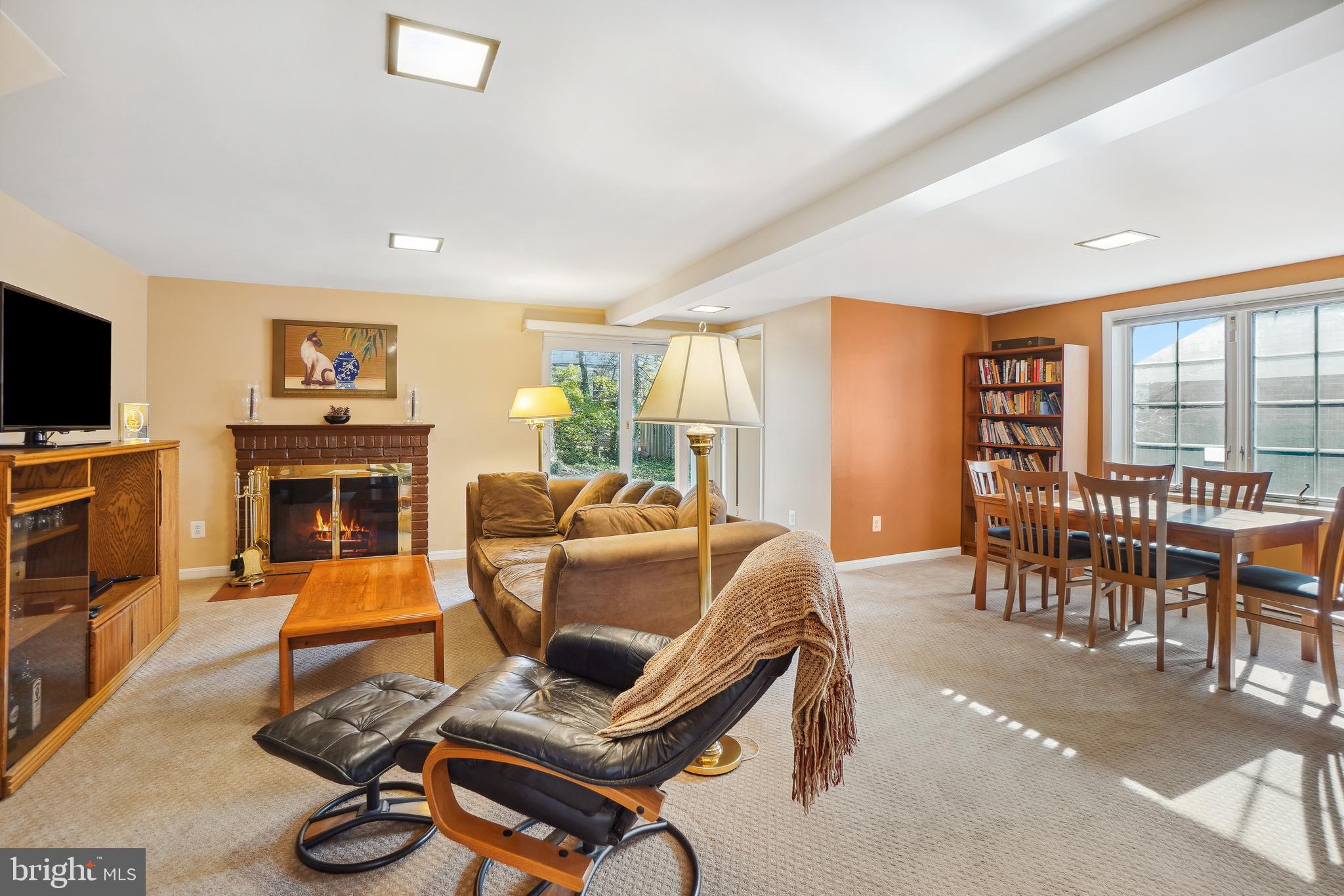 9127 Kirkdale Road Bethesda, MD 20817 - Photo 25 of 34 a living room with furniture a flat screen tv and a fireplace