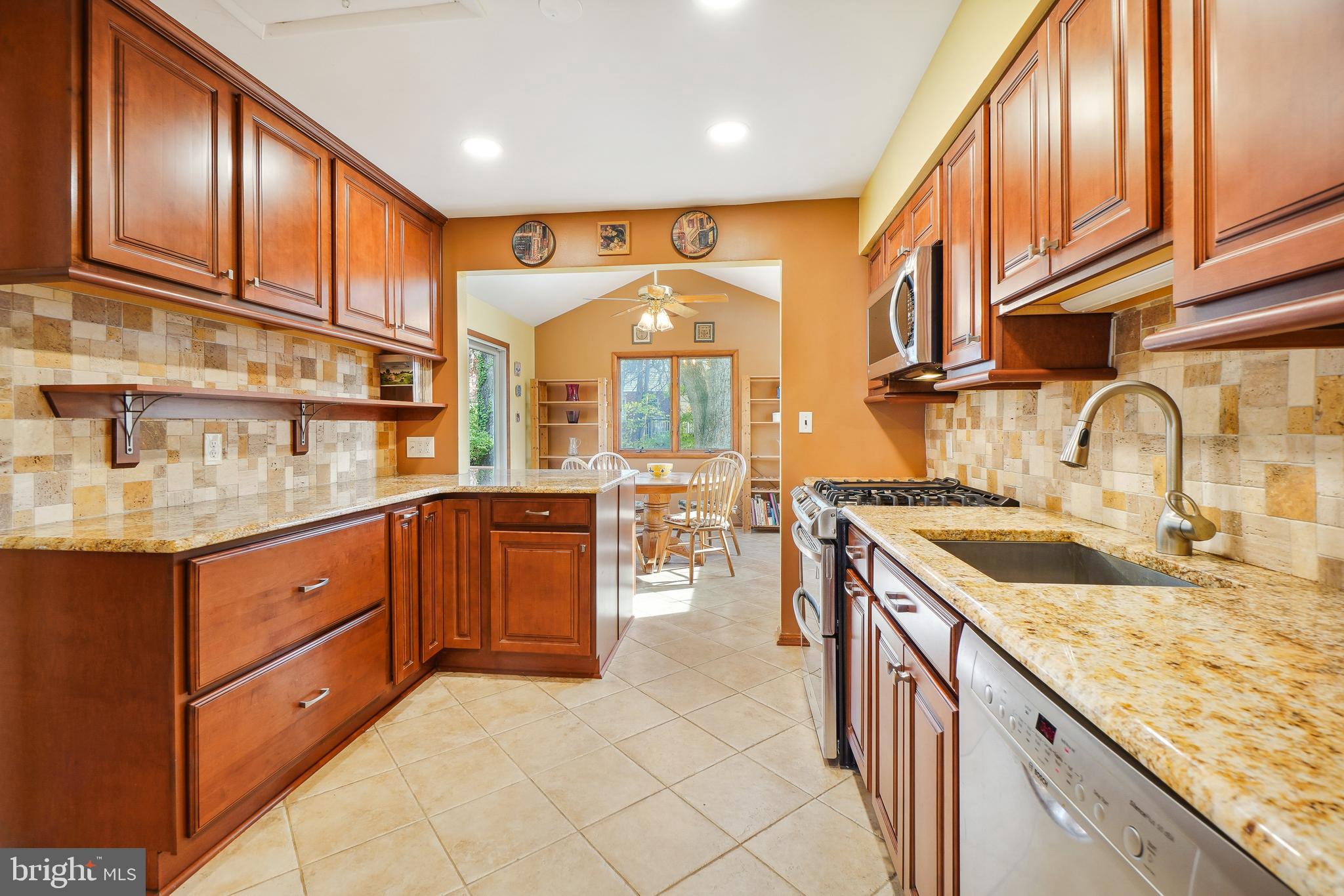 9127 Kirkdale Road Bethesda, MD 20817 - Photo 9 of 34 a kitchen with stainless steel appliances granite countertop a sink and cabinets