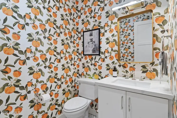 a bathroom with a sink and mirror with toilet
