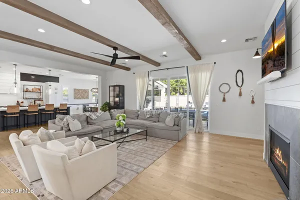 a living room with fireplace furniture and a flat screen tv