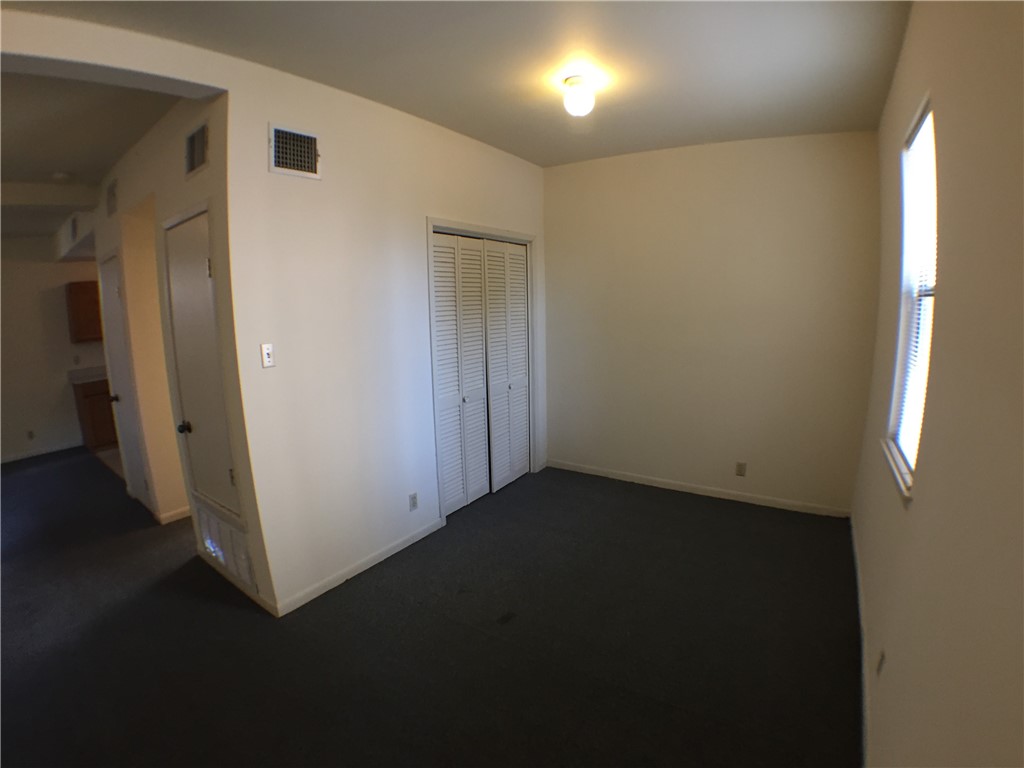 2307 Rio Grande Street, Unit E Austin, TX 78705 - Photo 2 of 2 an empty room with wooden floor and windows