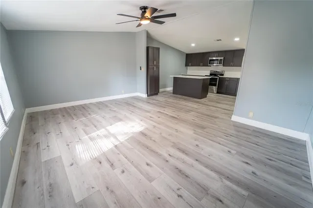 a view of a kitchen with a sink and wooden floor