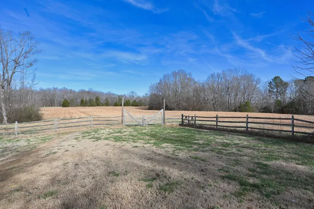 a view of a kitchen with kitchen island granite countertop a large counter top stainless steel appliances and cabinets