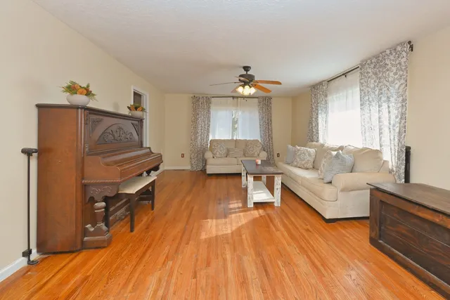 a living room with furniture and a chandelier