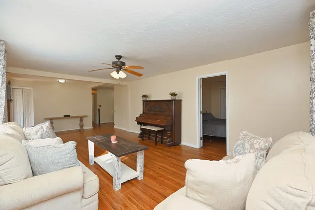 a view of a livingroom with furniture and hardwood floor