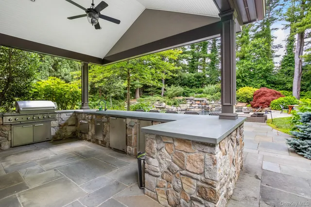 a view of a patio with a table chairs and a floor to ceiling window