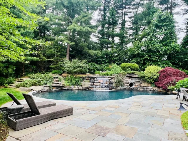 a view of a backyard with sitting area