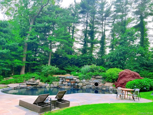 a view of a backyard with sitting area