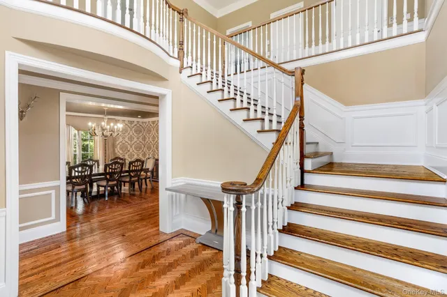a view of entryway and hall with wooden floor