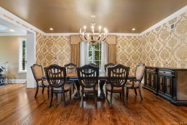 a view of a dining room with furniture wooden floor and chandelier