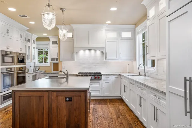 a kitchen with stainless steel appliances a sink stove and cabinets