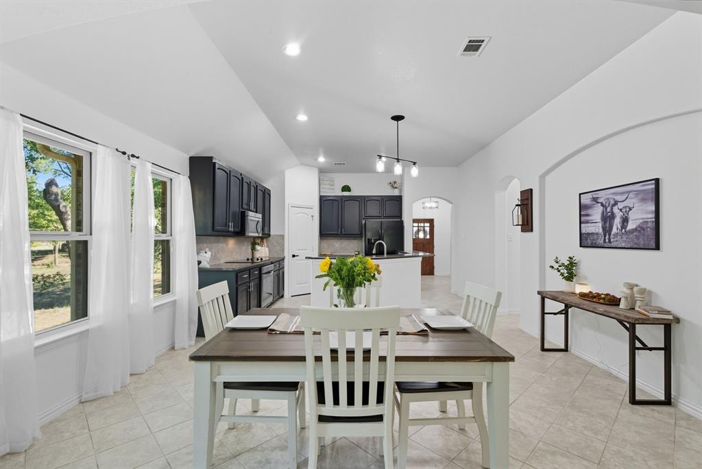 104 Candis Court Springtown, TX 76082 - Photo 11 of 40 a view of a dining room with furniture window and wooden floor