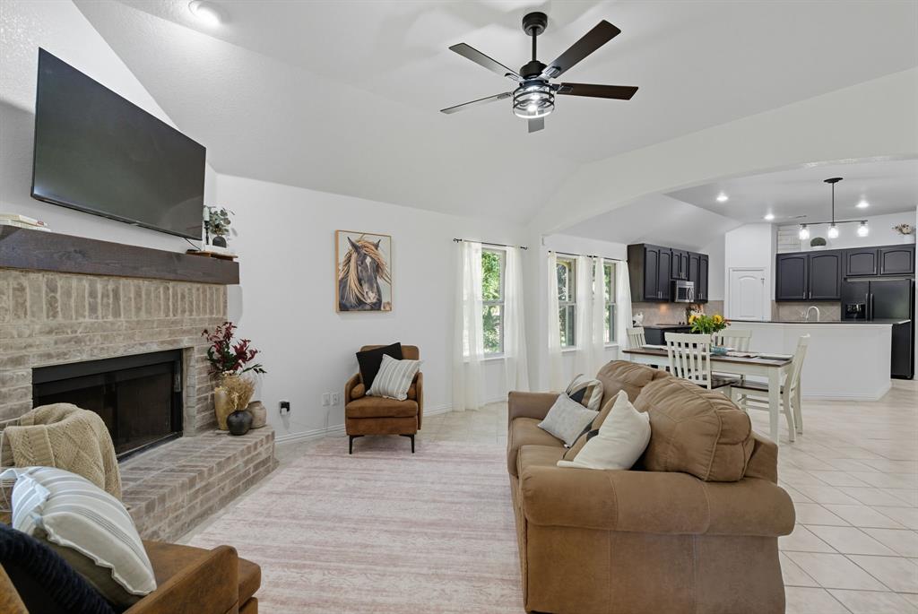 104 Candis Court Springtown, TX 76082 - Photo 12 of 40 a living room with furniture fireplace and a flat screen tv