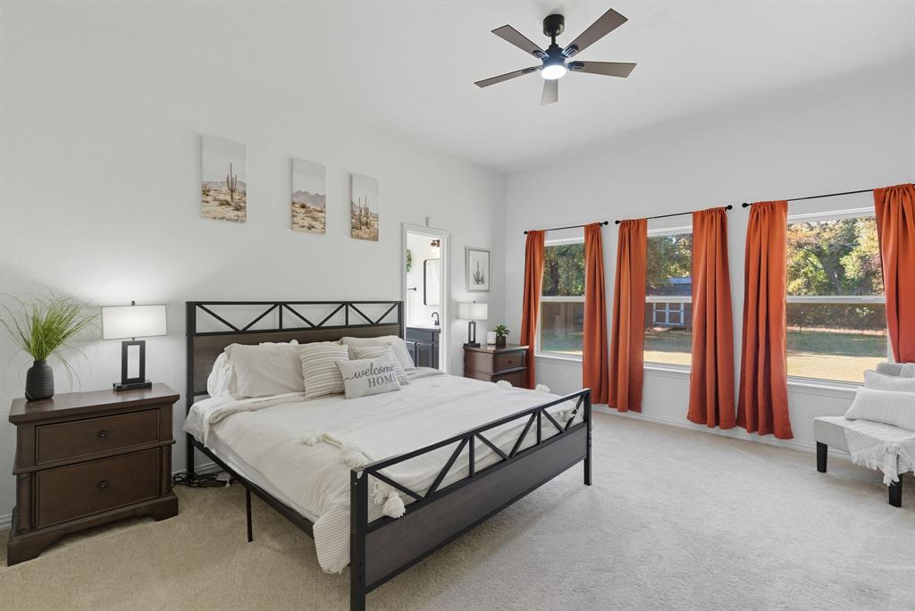 104 Candis Court Springtown, TX 76082 - Photo 17 of 40 a bedroom with a bed and a window