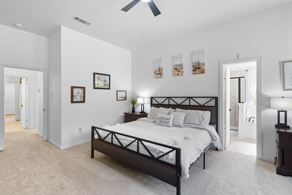 104 Candis Court Springtown, TX 76082 - Photo 18 of 40 a bedroom with a bed and a chandelier