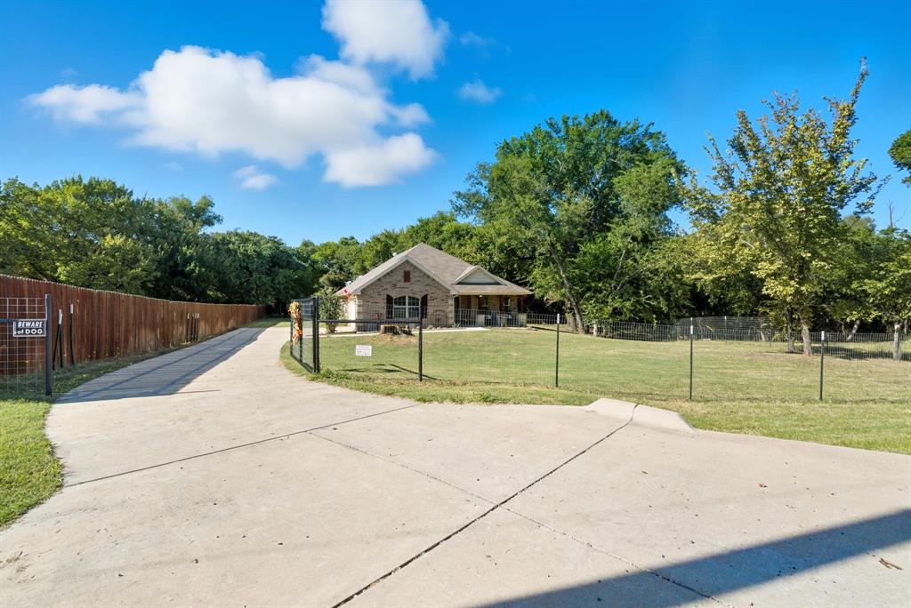 104 Candis Court Springtown, TX 76082 - Photo 2 of 40 a house with trees in the background