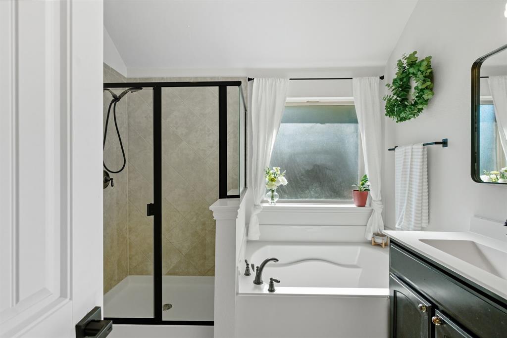 104 Candis Court Springtown, TX 76082 - Photo 19 of 40 a bathroom with a bathtub and a shower