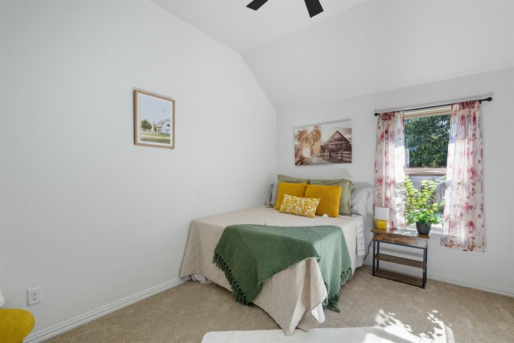 104 Candis Court Springtown, TX 76082 - Photo 21 of 40 a bedroom with a bed and a painting on the wall