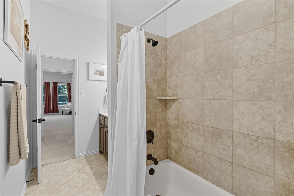 104 Candis Court Springtown, TX 76082 - Photo 22 of 40 a bathroom with a bathtub and a shower