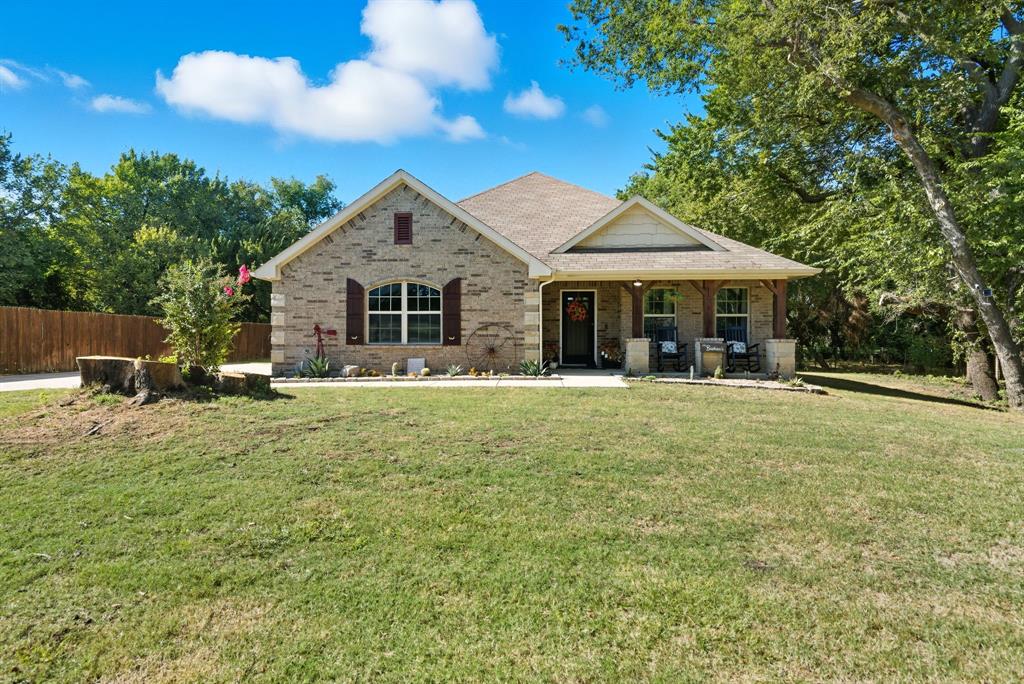 104 Candis Court Springtown, TX 76082 - Photo 4 of 40 a front view of a house with a yard