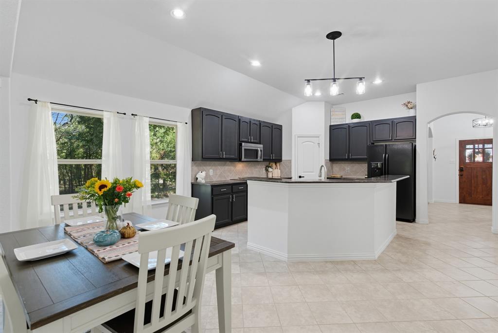 104 Candis Court Springtown, TX 76082 - Photo 8 of 40 a large kitchen with a table and chairs
