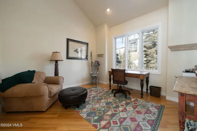 a bathroom with a toilet a sink a mirror a shower a vanity and window