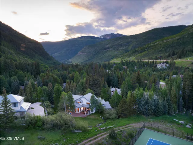 a view of a house with backyard and sitting area