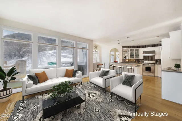 a living room with furniture potted plant and a fireplace