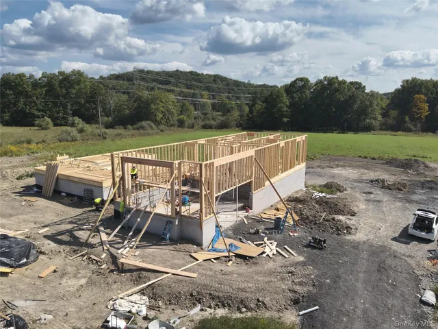 a view of a swimming pool with a patio and a yard