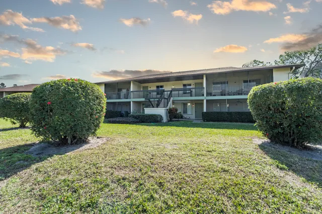a view of a house with a yard and garden