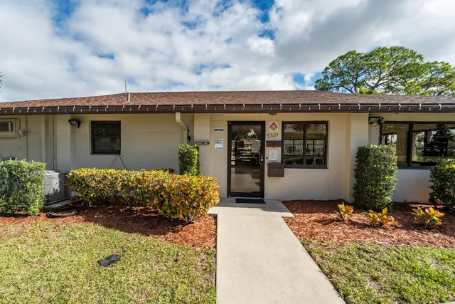 a view of house with outdoor space and sitting area