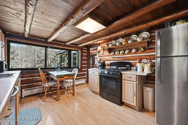 a kitchen with a stove a sink and a refrigerator