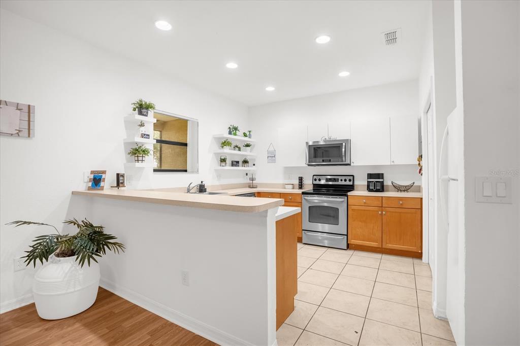 1374 Pacific Road Poinciana, FL 34759 - Photo 11 of 42 a kitchen with a sink stainless steel appliances and cabinets