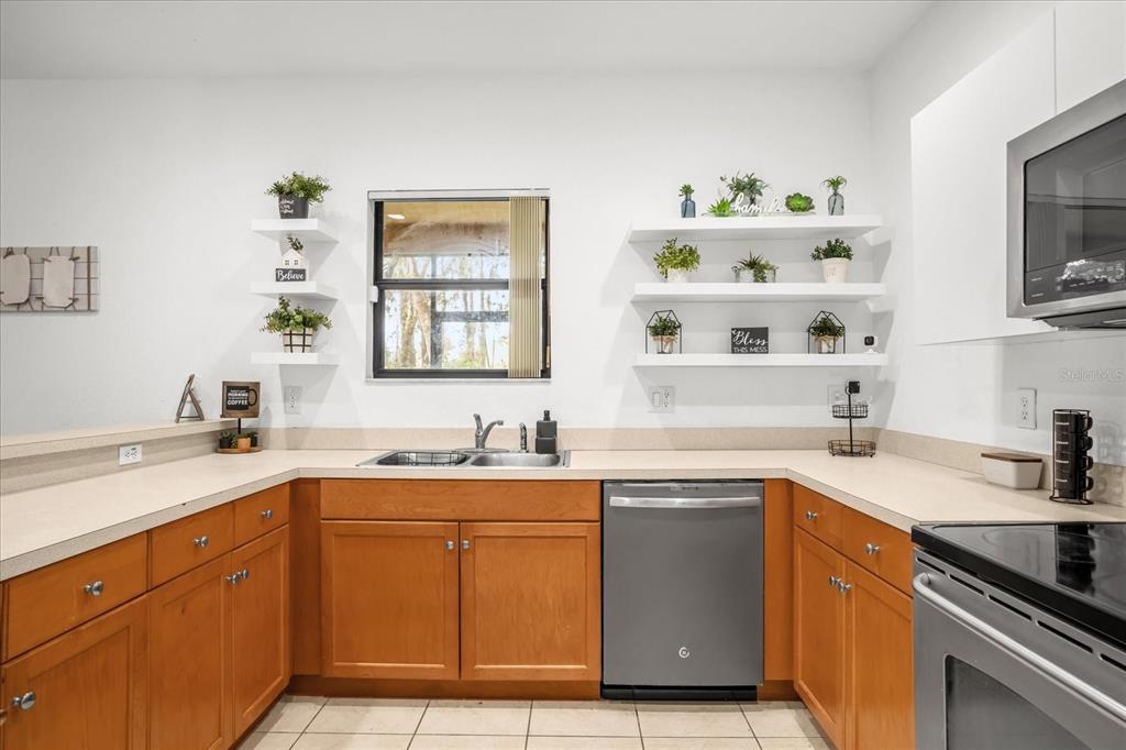 1374 Pacific Road Poinciana, FL 34759 - Photo 12 of 42 a kitchen with a sink dishwasher stove and cabinets