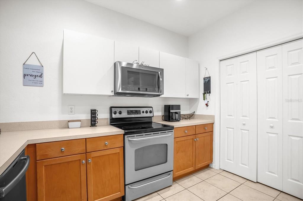 1374 Pacific Road Poinciana, FL 34759 - Photo 14 of 42 a kitchen with a sink stove and microwave