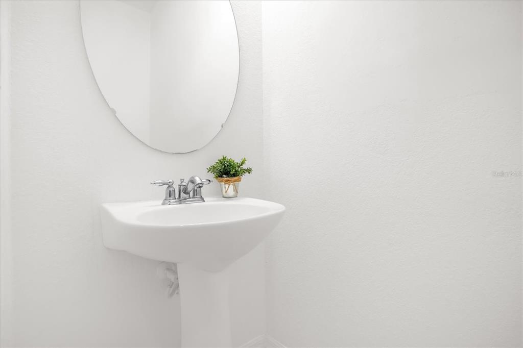 1374 Pacific Road Poinciana, FL 34759 - Photo 15 of 42 a bathroom with a sink and a mirror