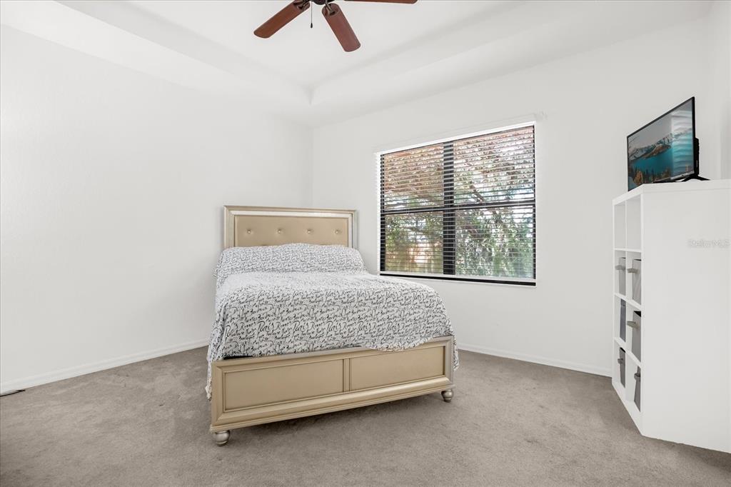 1374 Pacific Road Poinciana, FL 34759 - Photo 18 of 42 a bedroom with a bed and a window