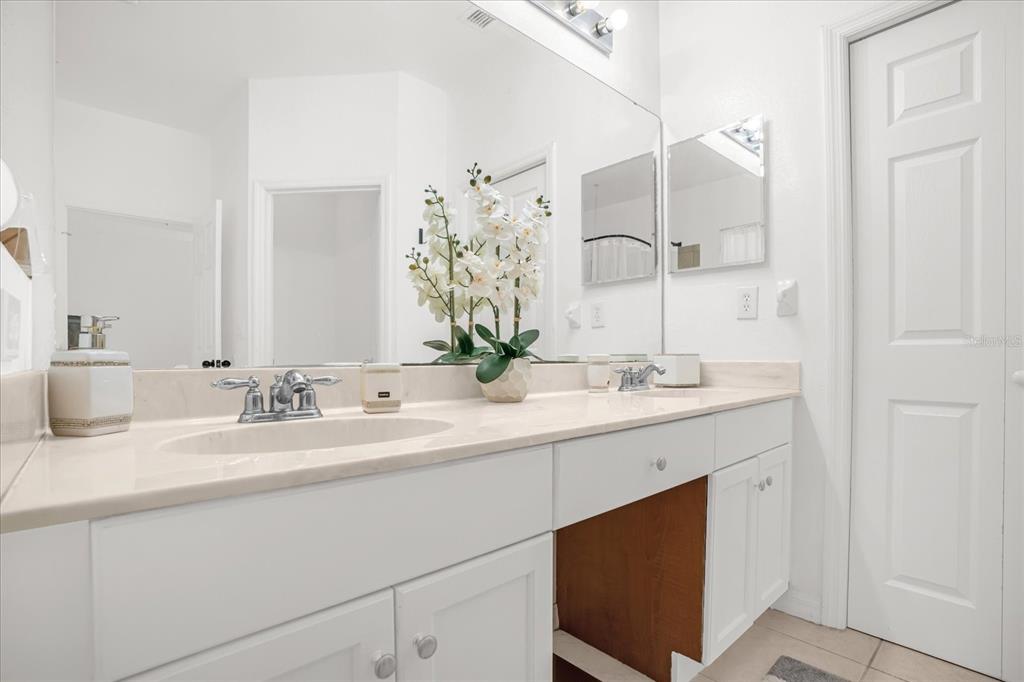1374 Pacific Road Poinciana, FL 34759 - Photo 20 of 42 a bathroom with double sink and a mirror