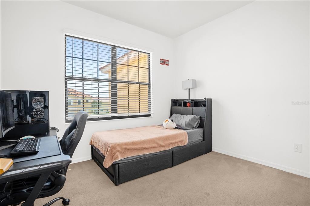 1374 Pacific Road Poinciana, FL 34759 - Photo 22 of 42 a bedroom with a bed and a couch