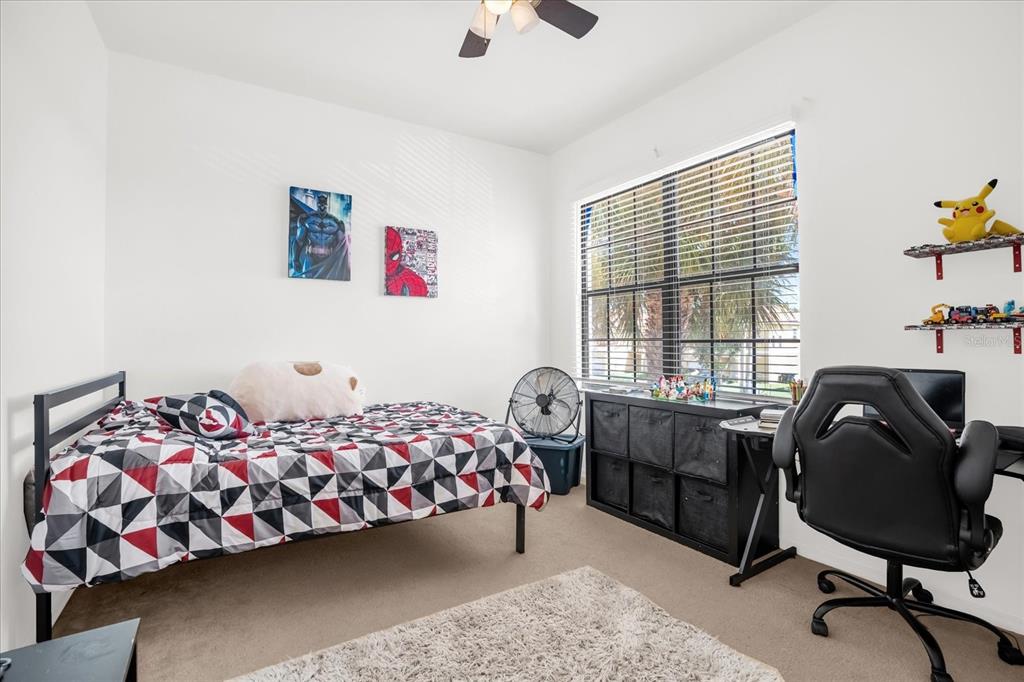 1374 Pacific Road Poinciana, FL 34759 - Photo 24 of 42 a bedroom with bed and a window