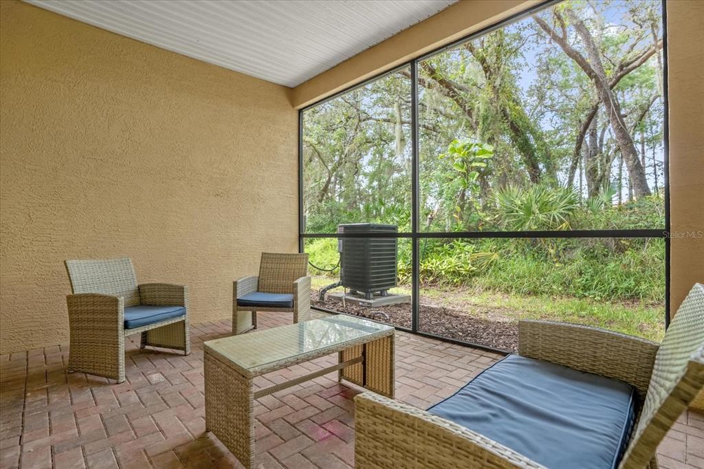 1374 Pacific Road Poinciana, FL 34759 - Photo 28 of 42 a living room with a floor to ceiling window and wooden floor