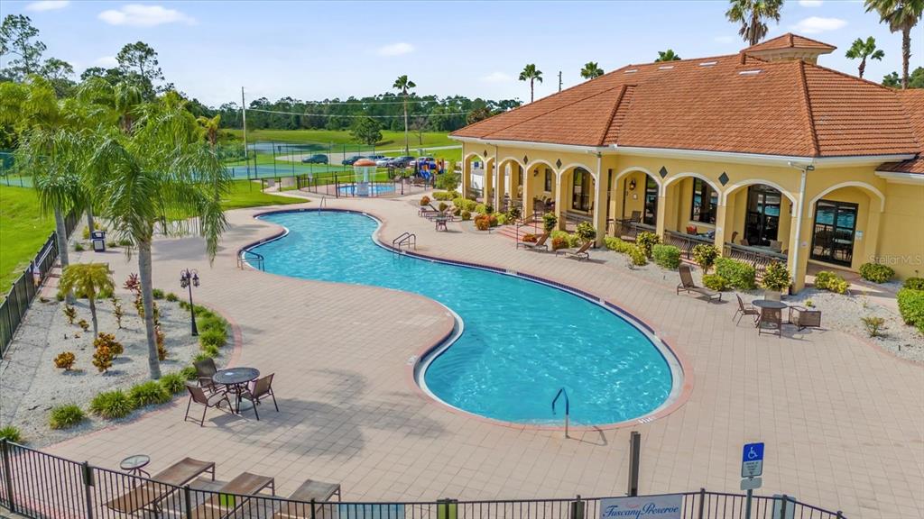 1374 Pacific Road Poinciana, FL 34759 - Photo 32 of 42 a view of a swimming pool with a patio