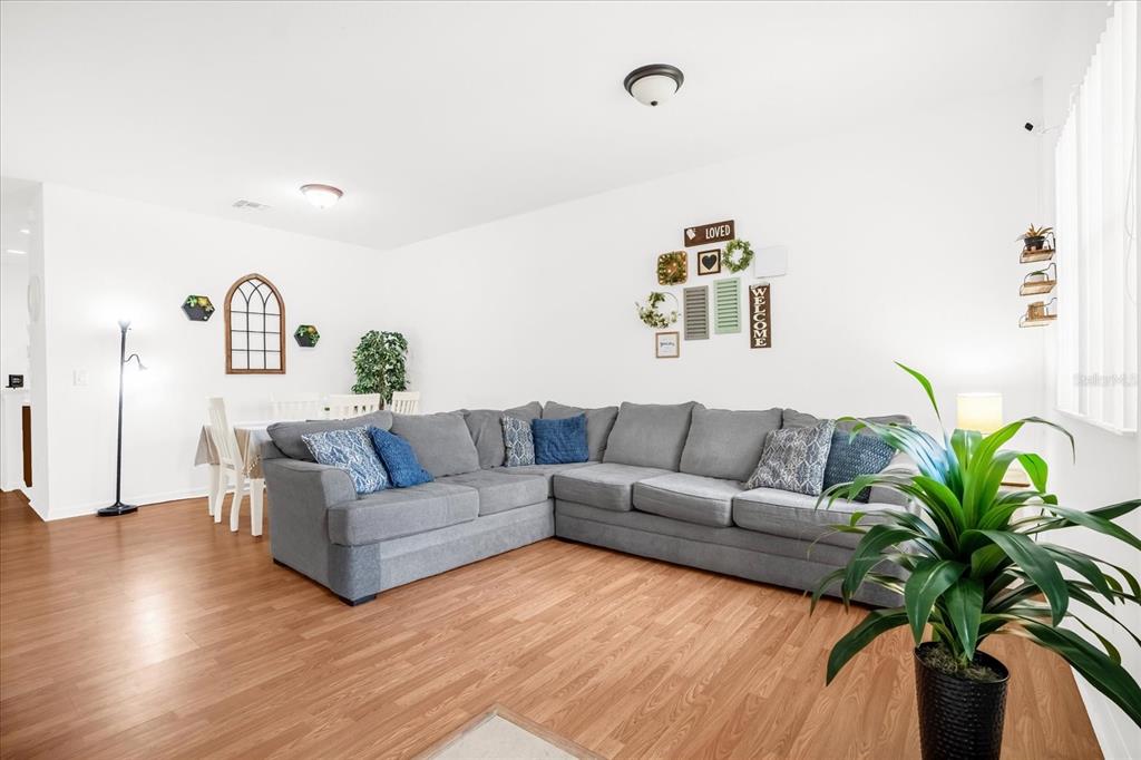 1374 Pacific Road Poinciana, FL 34759 - Photo 5 of 42 a living room with furniture and wooden floor