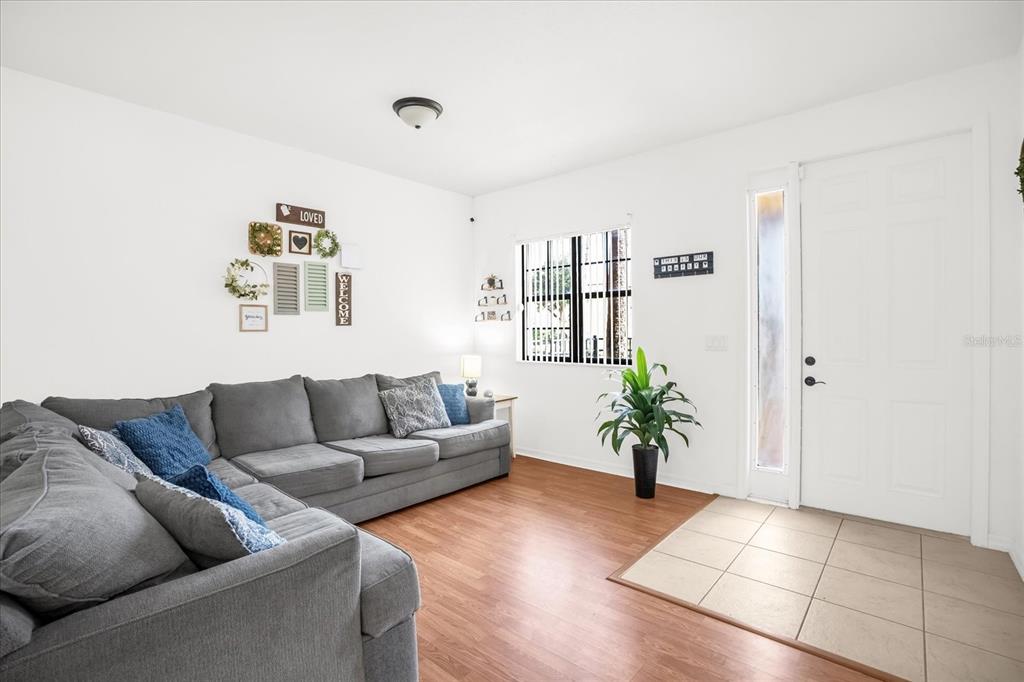 1374 Pacific Road Poinciana, FL 34759 - Photo 6 of 42 a living room with furniture and potted plant