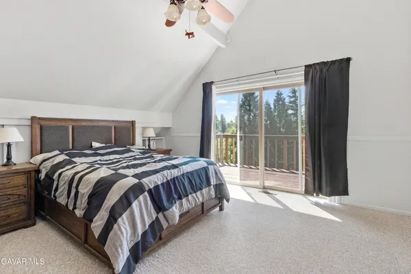a bedroom with a large bed and a large window