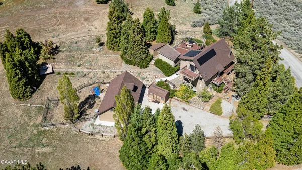 an aerial view of a house with a yard